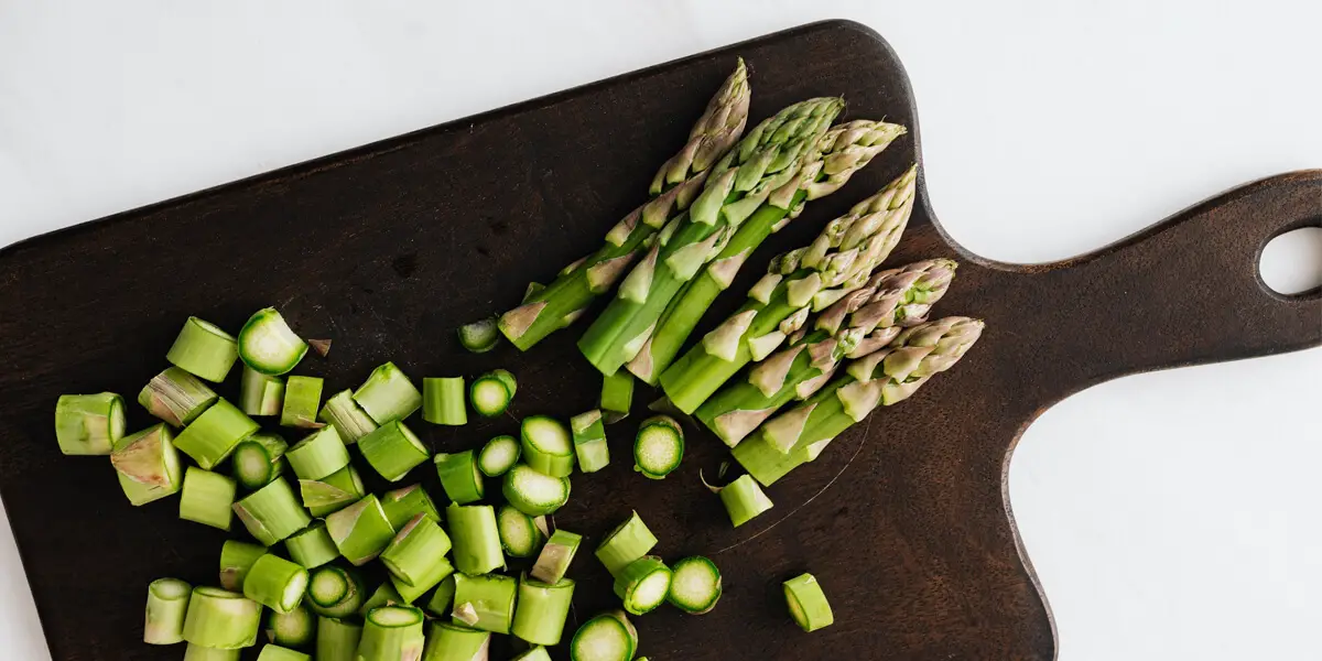 chopped asparagus on a chopping board